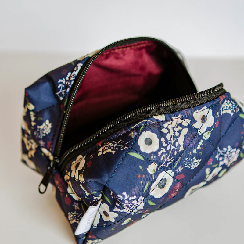 Floral-patterned pouch with a zipper on a light background