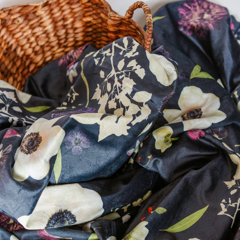 Floral-patterned throw with a wicker basket in the background