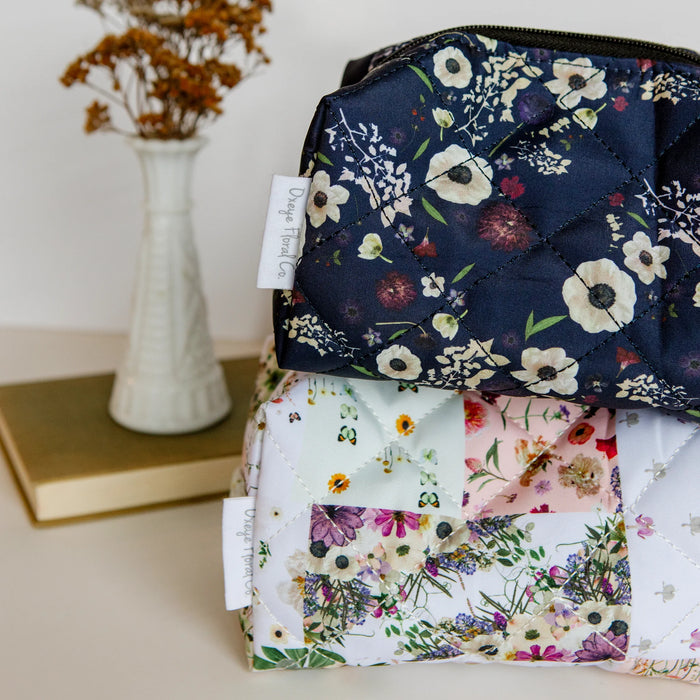 mini pouches with floral patchwork print and dark floral print with a vase and book in the background