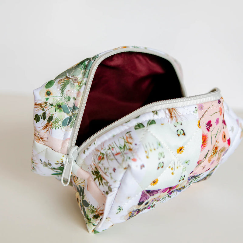 Floral-patterned cosmetic bag on a light background
