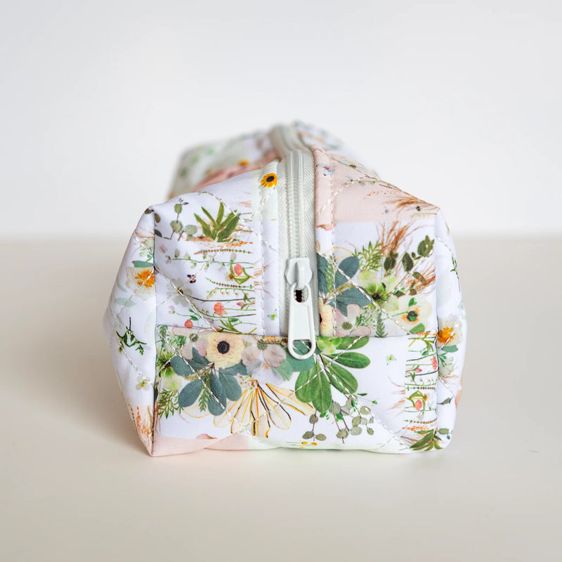 Floral-patterned bag with a zipper on a light background