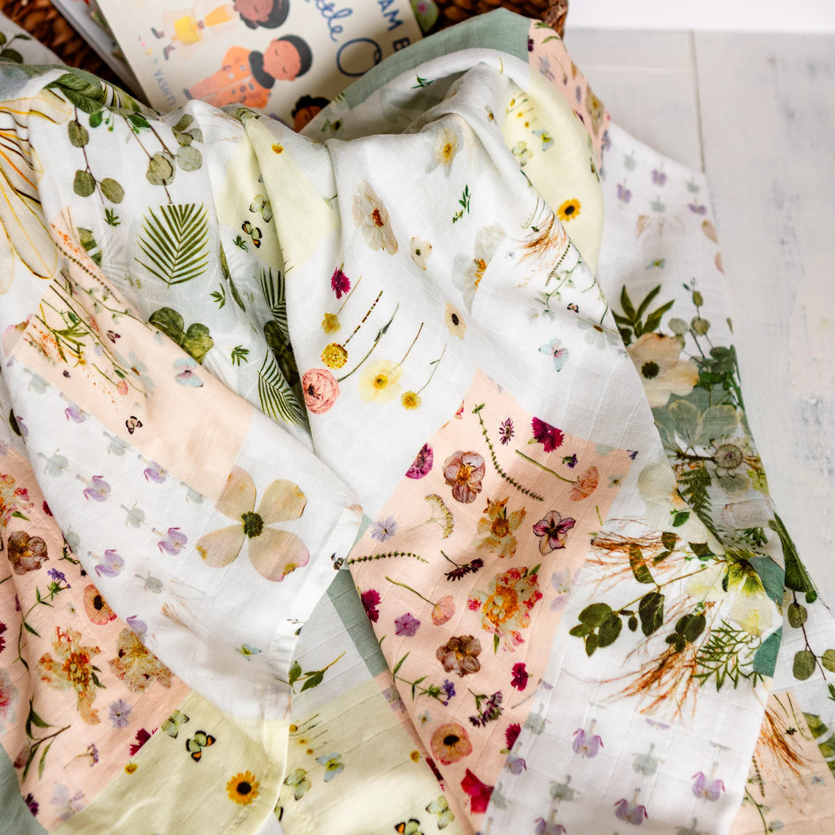Pressed flower picnic-style baby swaddle in a basket