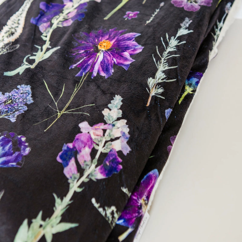 Dark fabric  throw blanket with colorful floral patterns