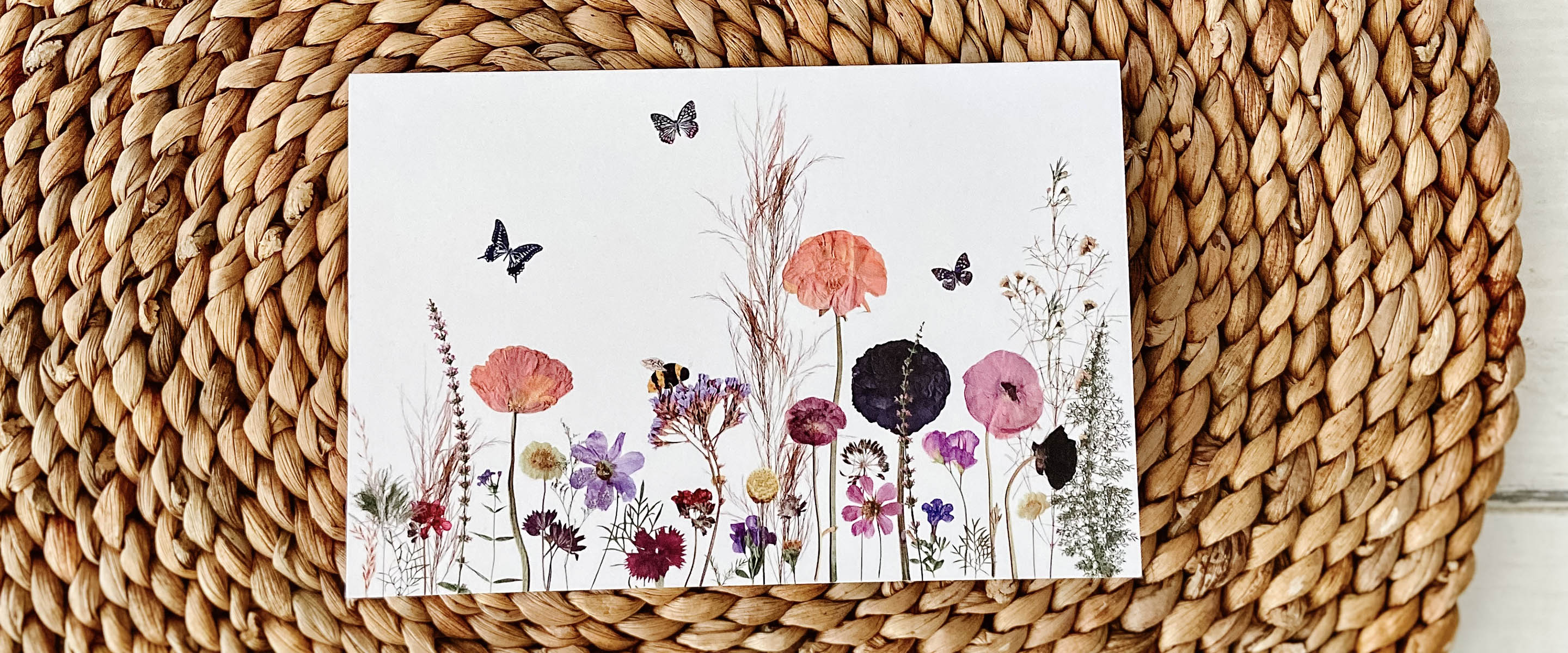 Pressed flower greeting card with butterflies and bees